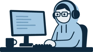 An engineer in a hoodie at a desk, typing